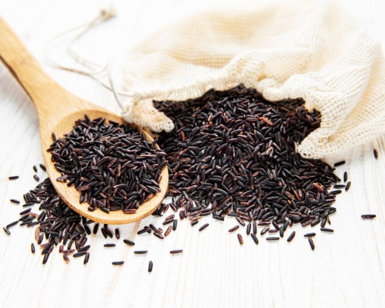 Uncooked Wild Rice On A White Wooden Background